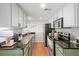 Well-equipped kitchen with granite countertops, modern appliances, and stylish white cabinetry at 6900 Roswell Rd # J2, Atlanta, GA 30328