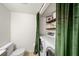 Laundry area with white washer and dryer, toilet, and custom curtain for privacy at 6900 Roswell Rd # J2, Atlanta, GA 30328