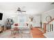 Bright living room with hardwood floors, a cozy white sofa, and a ceiling fan for added comfort at 6900 Roswell Rd # J2, Atlanta, GA 30328