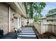 Cozy outdoor patio with stylish furniture, a striped rug, and a privacy fence at 6900 Roswell Rd # J2, Atlanta, GA 30328