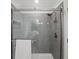 Modern bathroom shower featuring gray subway tile, a glass door, and sleek shower head at 6900 Roswell Rd # J2, Atlanta, GA 30328