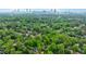 An aerial view of a lush, green neighborhood and the skyline of Atlanta at 893 E Rock Springs Ne Rd, Atlanta, GA 30306