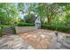 A well-maintained backyard with a detached garage, a patio, and lush greenery at 893 E Rock Springs Ne Rd, Atlanta, GA 30306