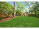 Large, green backyard with playground, seating and mature trees at 893 E Rock Springs Ne Rd, Atlanta, GA 30306