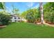 Lush backyard with expansive lawn, mature trees, and play set at 893 E Rock Springs Ne Rd, Atlanta, GA 30306