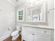 Bright bathroom featuring a marble-topped vanity, a classic framed mirror, and wood-look floors for a touch of warmth at 893 E Rock Springs Ne Rd, Atlanta, GA 30306