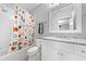 Bright bathroom featuring modern vanity, a full size mirror, and a shower tub at 893 E Rock Springs Ne Rd, Atlanta, GA 30306