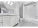Clean bathroom with marble countertop, dual sinks, and a shower and tub at 893 E Rock Springs Ne Rd, Atlanta, GA 30306