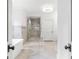 Bright bathroom featuring a soaking tub, a glass-enclosed shower, and marble tile for a spa-like experience at 893 E Rock Springs Ne Rd, Atlanta, GA 30306