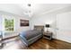 Well-lit bedroom features hardwood floors, modern lighting, and a window view with a comfortable bed and stylish decor at 893 E Rock Springs Ne Rd, Atlanta, GA 30306