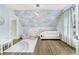 ' bedroom with hardwood floors and rainbow rug features vaulted ceiling with cloud wallpaper at 893 E Rock Springs Ne Rd, Atlanta, GA 30306