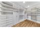 Spacious walk-in closet with custom shelves, drawers and cabinetries and hardwood floor at 893 E Rock Springs Ne Rd, Atlanta, GA 30306