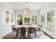 Bright dining room with a wooden table, modern chairs, and large windows overlooking the backyard at 893 E Rock Springs Ne Rd, Atlanta, GA 30306