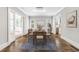 Well-lit dining room with hardwood floors, stylish lighting, and a view of the sunroom at 893 E Rock Springs Ne Rd, Atlanta, GA 30306