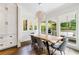 Dining room with a wooden table, modern chairs, and large windows overlooking the backyard at 893 E Rock Springs Ne Rd, Atlanta, GA 30306