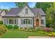 Charming Tudor-style home with stone accents, manicured lawn, and lush landscaping at 893 E Rock Springs Ne Rd, Atlanta, GA 30306