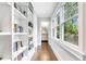 Bright hallway with built-in bookshelves and windows providing natural light and backyard views at 893 E Rock Springs Ne Rd, Atlanta, GA 30306