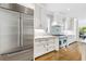 Stylish kitchen features stainless steel appliances, white cabinets, marble countertops, and a modern backsplash at 893 E Rock Springs Ne Rd, Atlanta, GA 30306