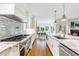 Gourmet kitchen boasts marble counters, stainless appliances, tile backsplash, and open floor plan at 893 E Rock Springs Ne Rd, Atlanta, GA 30306