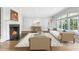 Bright living room featuring a cozy fireplace, hardwood floors, and large windows at 893 E Rock Springs Ne Rd, Atlanta, GA 30306