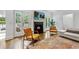 Cozy living room with fireplace, mounted television, hardwood floors, and doors to backyard at 893 E Rock Springs Ne Rd, Atlanta, GA 30306