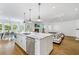 Open-concept living room with kitchen island, fireplace, and hardwood floors creates an inviting space at 893 E Rock Springs Ne Rd, Atlanta, GA 30306