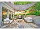Inviting patio with stone floor, white furniture, grill, and overhead shade for outdoor entertaining at 893 E Rock Springs Ne Rd, Atlanta, GA 30306