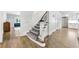 Elegant staircase with patterned carpet, white railings, and dark wood trim, connecting different levels of the home at 893 E Rock Springs Ne Rd, Atlanta, GA 30306