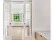 Bright sunroom featuring glass doors, hardwood floors, and natural light, perfect for relaxation or entertaining at 893 E Rock Springs Ne Rd, Atlanta, GA 30306