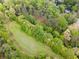 Picturesque aerial view of a lush neighborhood featuring walking paths, dense trees, and serene creek views at 101 Ardmore Nw Pl # 3, Atlanta, GA 30309
