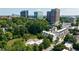 Modern townhouses nestled among mature trees with a backdrop of a vibrant city skyline at 101 Ardmore Nw Pl # 3, Atlanta, GA 30309
