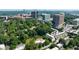 Modern townhouses nestled among mature trees with a backdrop of a vibrant city skyline at 101 Ardmore Nw Pl # 3, Atlanta, GA 30309