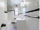 Classic bathroom featuring white tile with black trim, updated vanity, and a shower-tub combo at 101 Ardmore Nw Pl # 3, Atlanta, GA 30309