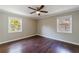 A cozy bedroom featuring hardwood floors, two windows, and a ceiling fan at 101 Ardmore Nw Pl # 3, Atlanta, GA 30309