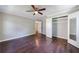 Spacious bedroom featuring dark hardwood floors, a ceiling fan, and a closet with mirrored doors at 101 Ardmore Nw Pl # 3, Atlanta, GA 30309