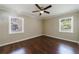 Bedroom featuring wood floors, neutral paint, two windows, and a ceiling fan at 101 Ardmore Nw Pl # 3, Atlanta, GA 30309