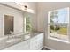 Modern bathroom featuring double sinks, granite countertops, and white cabinets at 1492 Saint George, Conyers, GA 30012