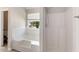 Clean bathroom with white tile bathtub, shower, and a window providing natural light at 1492 Saint George, Conyers, GA 30012