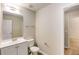 Bright bathroom features a single sink vanity, mirror, and toilet on wood-look flooring at 1492 Saint George, Conyers, GA 30012