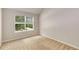 Bedroom featuring neutral carpet, a window, and fresh neutral paint at 1492 Saint George, Conyers, GA 30012