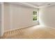 Carpeted bedroom with a window showing trees and a white tray ceiling at 1492 Saint George, Conyers, GA 30012