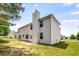Back of a white two-story house with a chimney and green grass at 1492 Saint George, Conyers, GA 30012