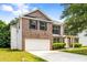 Charming two-story brick home featuring an attached garage and well-maintained lawn at 1492 Saint George, Conyers, GA 30012