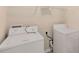 Functional laundry room area with washer and dryer hookups, and shelving for storage at 1492 Saint George, Conyers, GA 30012