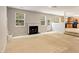 Cozy living room featuring fireplace, neutral carpeting, and easy kitchen access at 1492 Saint George, Conyers, GA 30012