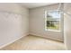 Spacious walk-in closet with neutral carpeting, a window for natural light, and ample shelving at 1492 Saint George, Conyers, GA 30012