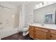 Clean bathroom with wood vanity, a tub/shower combo, and neutral finishes at 1680 Bluestone Dr, Cumming, GA 30041