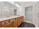 Bathroom featuring double sinks, granite counters, and a glass door shower at 1680 Bluestone Dr, Cumming, GA 30041