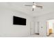 Bedroom showcasing ceiling fan, installed television, and ensuite bathroom at 1680 Bluestone Dr, Cumming, GA 30041