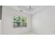 Minimalist bedroom with light neutral colors and a large window at 1680 Bluestone Dr, Cumming, GA 30041